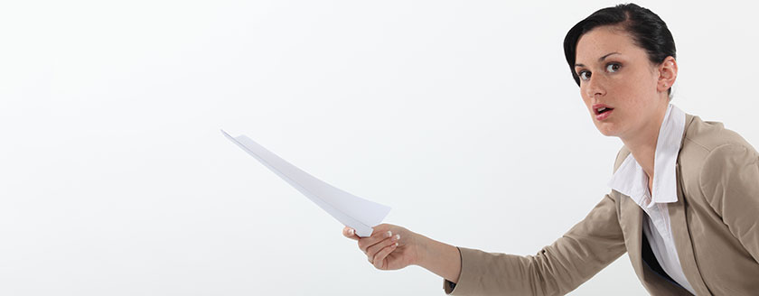 Young Woman Holding Out Piece of Paper